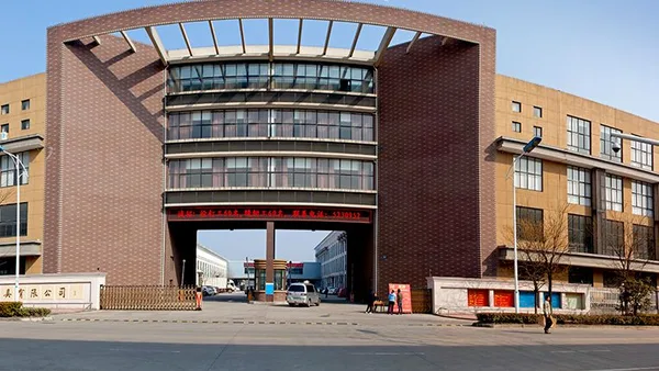 Zhejiang Grand Orient Chair Industry factory campus in Anji — brick production and office building with the company gate and stone name plaques